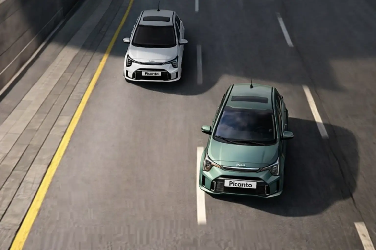 Two Kia Picanto cars moving in a highway