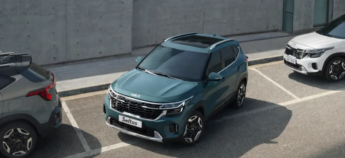 Three kia seltos suvs parked