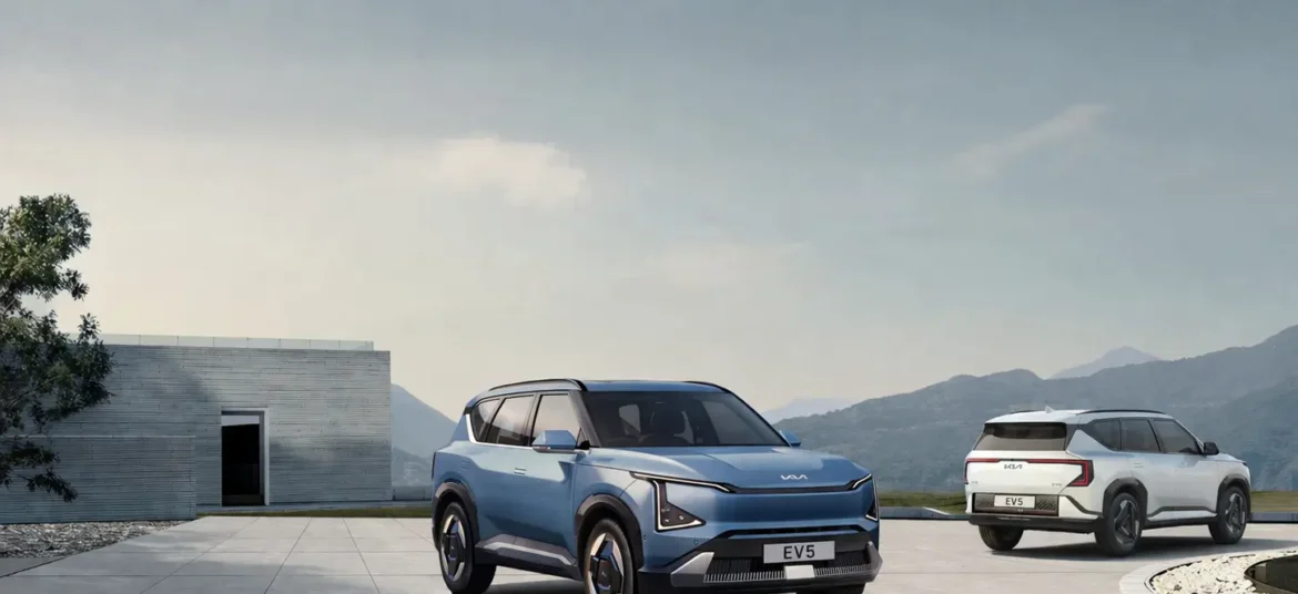 Two Kia EV5 electric SUVs parked infront of a box type of building