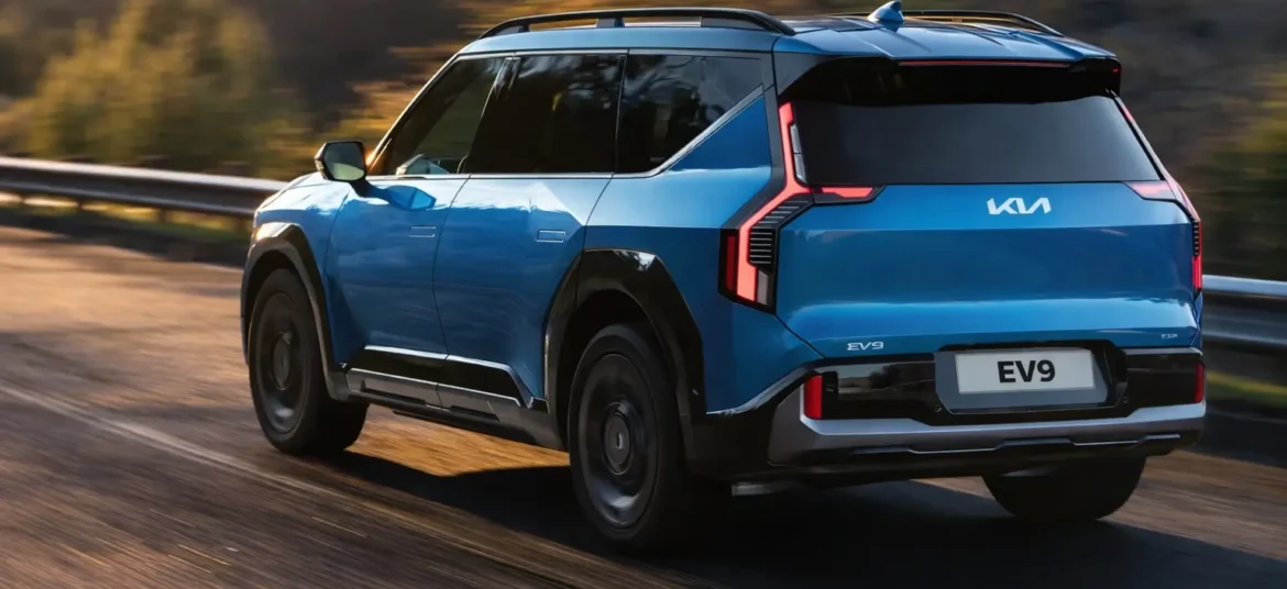 An ocean blue color kia EV9 electric SUV on a highway