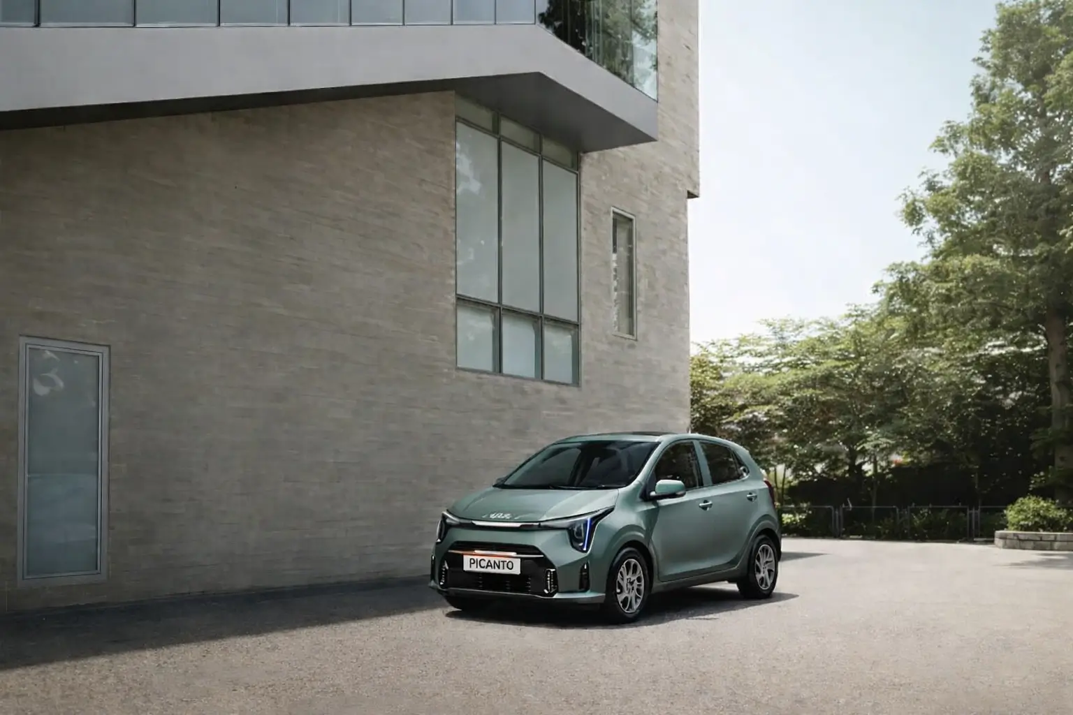 An Adventorous Green color kia picanto car parked near a building